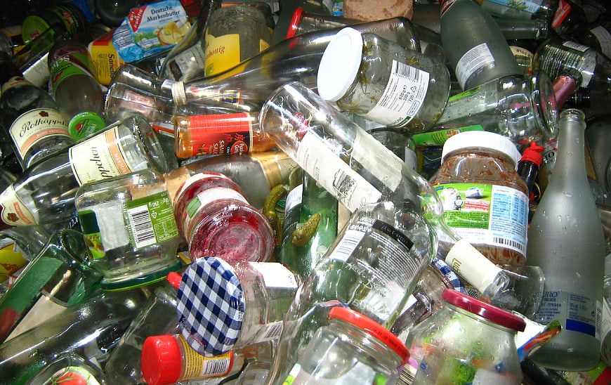 Pile of mixed glass bottles and jars for recycling