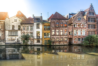 Historic canal houses in Ghent, Belgium with water reflections