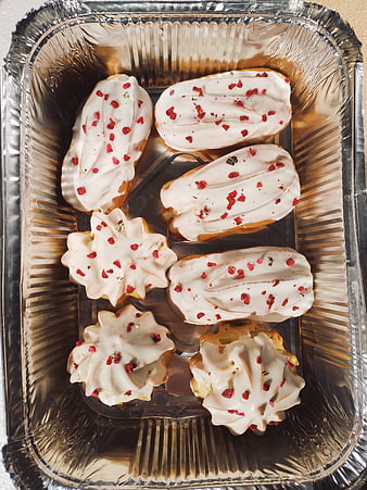 Homemade Eclairs with White Icing in Foil Tray