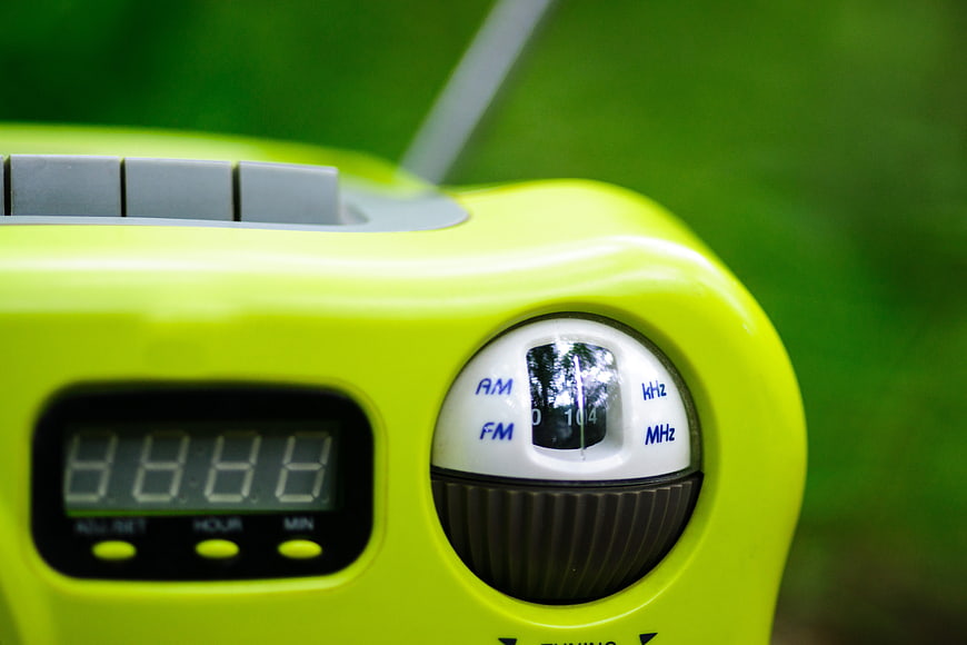 Close-up of bright yellow digital radio with tuning dial