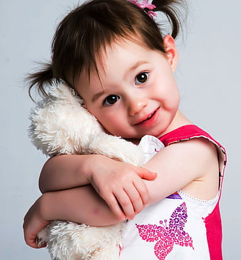 Cute Toddler Girl Hugging White Stuffed Animal