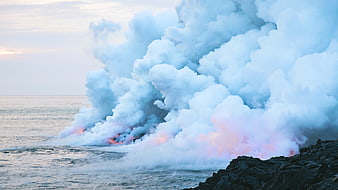 Volcanic Lava Flowing into Ocean Creating Steam Plume