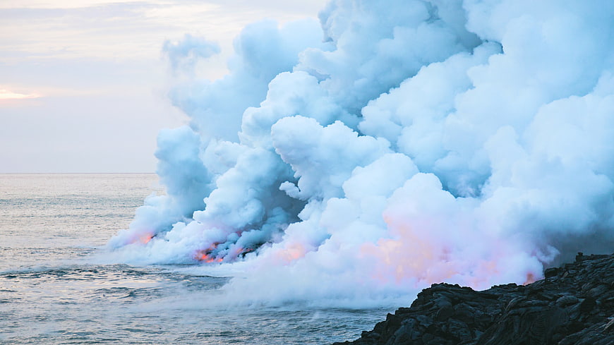 Volcanic Lava Flowing into Ocean Creating Steam Plume