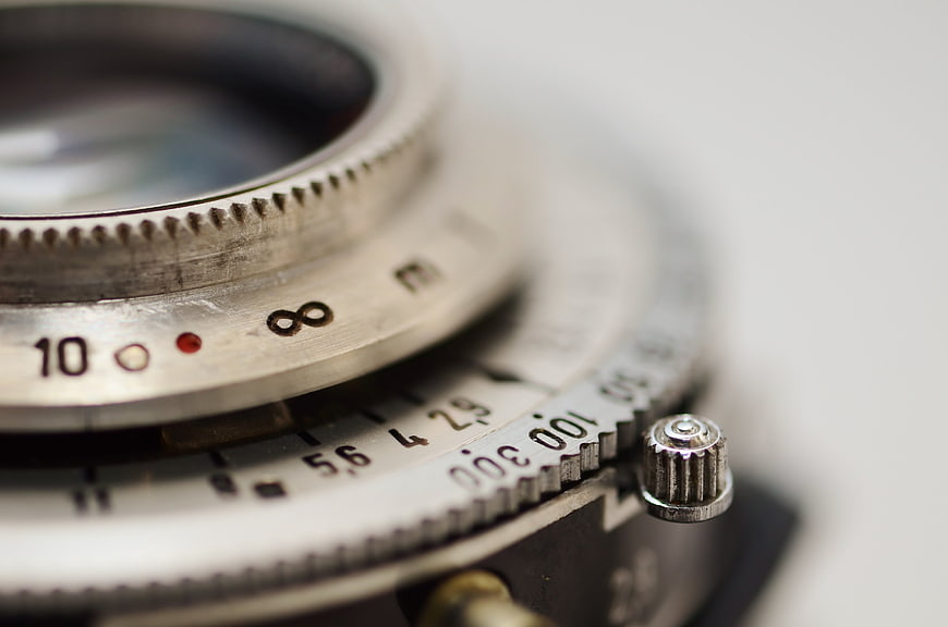 Close-up of vintage camera lens with infinity focus symbol