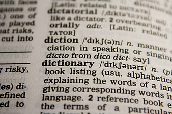 Close-up of dictionary page focusing on the word dictionary definition