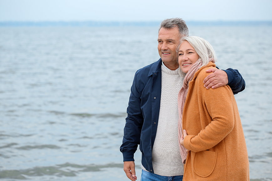 Happy Senior Couple Embracing by the Sea