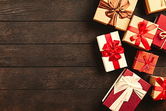 Christmas Gift Boxes With Red Ribbons On Dark Wooden Table