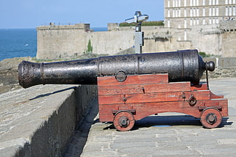 Historic Cannon on Stone Ramparts Overlooking the Sea