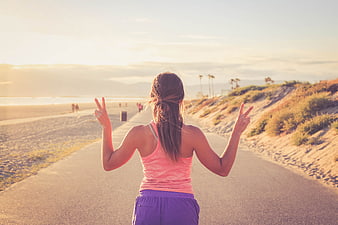 Woman Jogging On Beach Path At Sunset