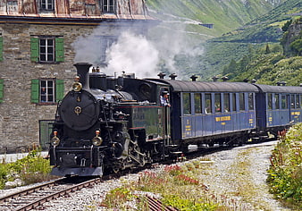Historic Steam Locomotive at Furka Pass Station in Swiss Alps