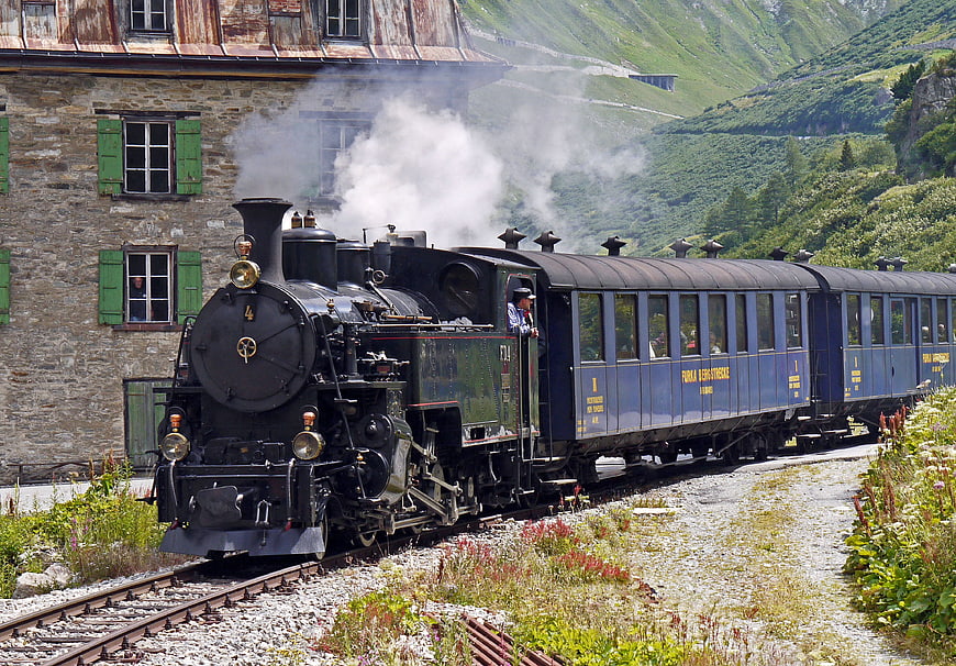 Historic Steam Locomotive at Furka Pass Station in Swiss Alps