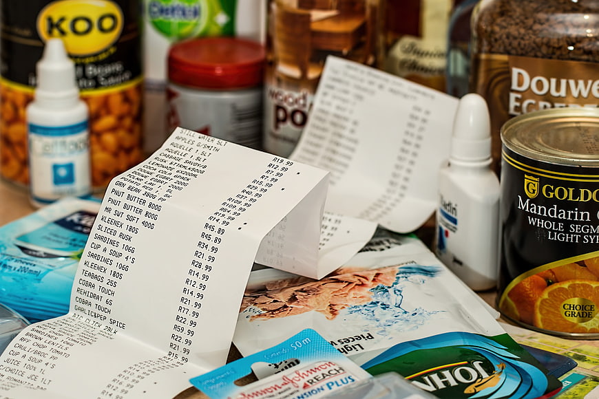 Grocery Receipts and Supermarket Products on a Table