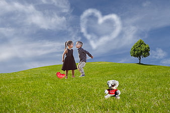 Children about to kiss on green hill with heart cloud