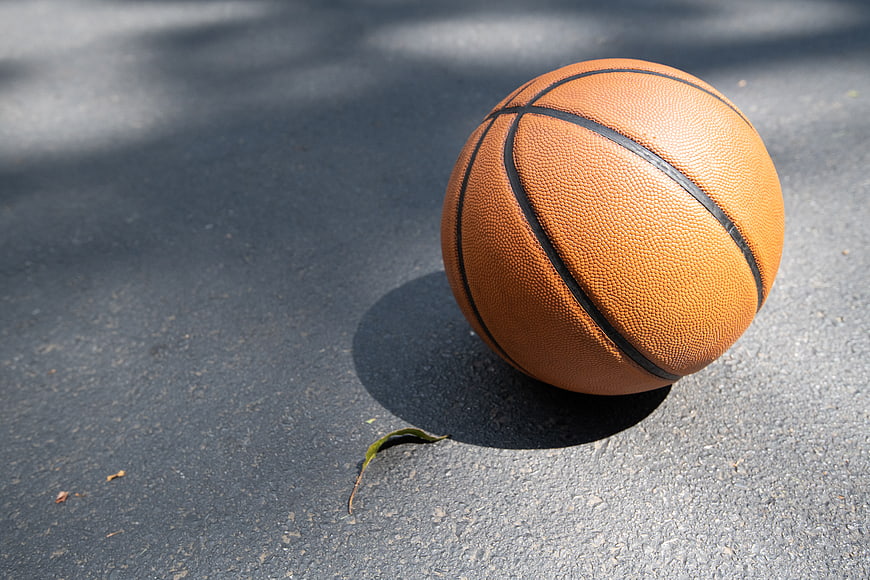 Orange Basketball on Asphalt Court with Copy Space