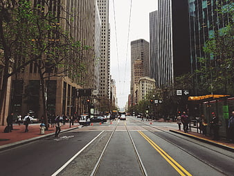 Urban street view with tram tracks and skyscrapers