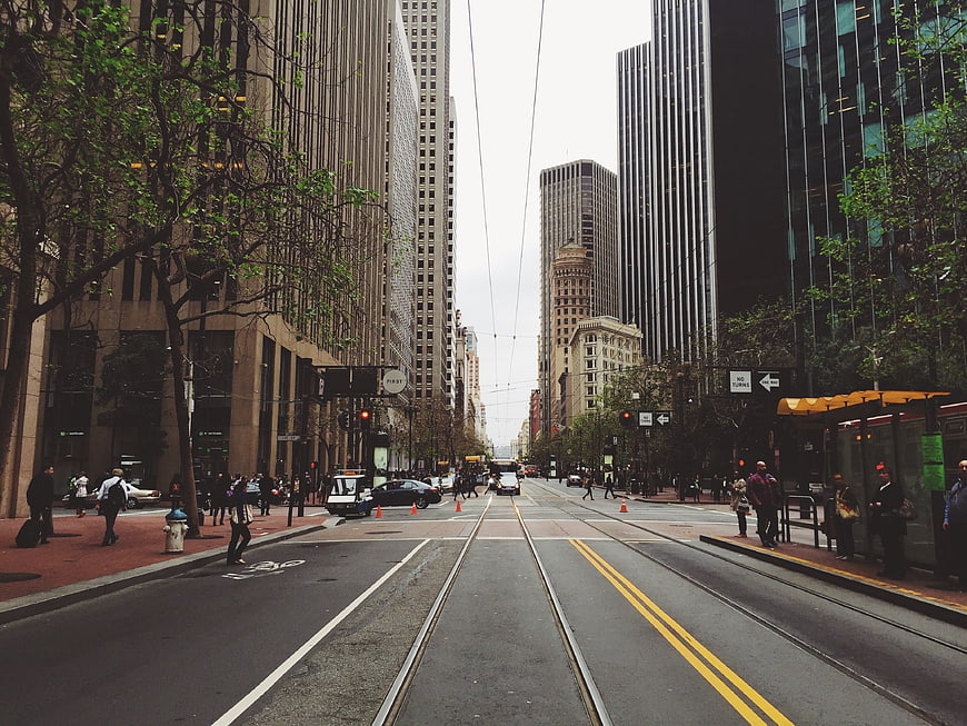 Urban street view with tram tracks and skyscrapers