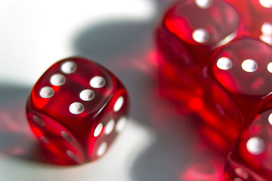 Close-up of red translucent dice on a white surface