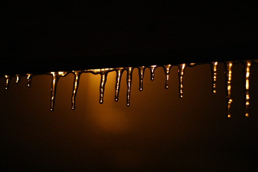 Golden icicles dripping against dark background