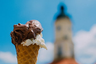 Chocolate and Vanilla Ice Cream Cone Against Blue Sky