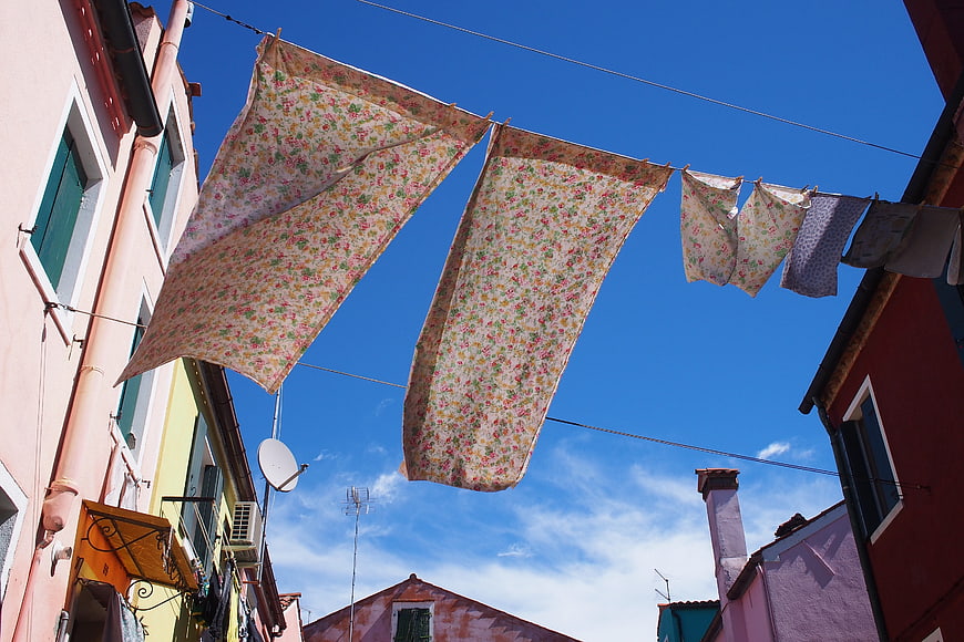 Floral laundry hanging on line against blue sky in Venice