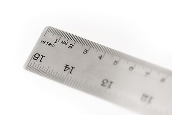 Close-up of a metal metric ruler on a white background