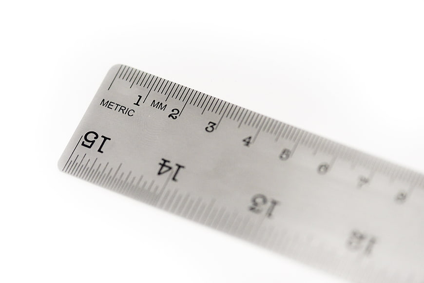 Close-up of a metal metric ruler on a white background