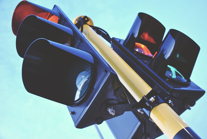 Low angle view of traffic lights against blue sky