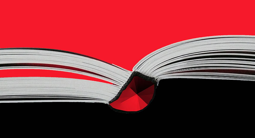 Open Book with Red Gemstone on Red and Black Background
