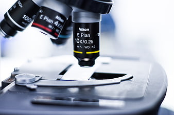 Close-up of Nikon microscope objective lens on laboratory stage