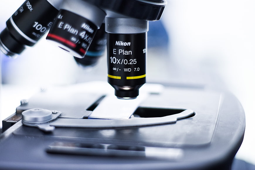 Close-up of Nikon microscope objective lens on laboratory stage