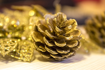 Close-up of Gold Glitter Pine Cone Christmas Decoration