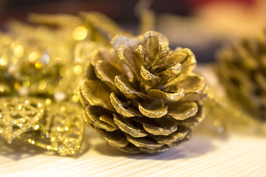 Close-up of Gold Glitter Pine Cone Christmas Decoration