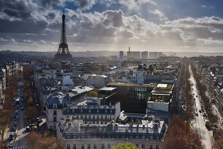 Aerial View of Paris Cityscape with Eiffel Tower and Dramatic Clouds