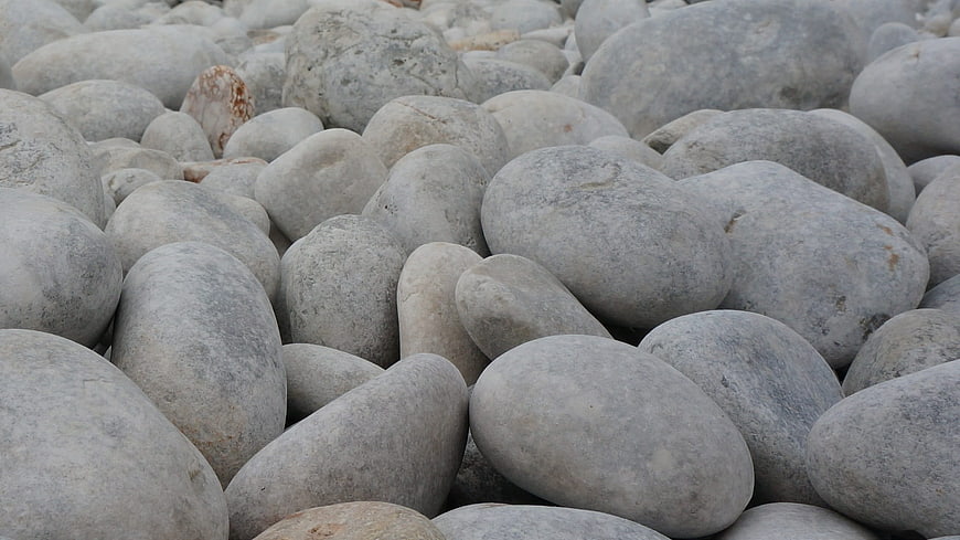Close-up of smooth gray river stones and pebbles