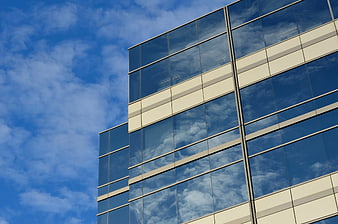 Modern Glass Office Building with Cloud Reflections