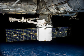 Spacecraft Docked at International Space Station Over Earth