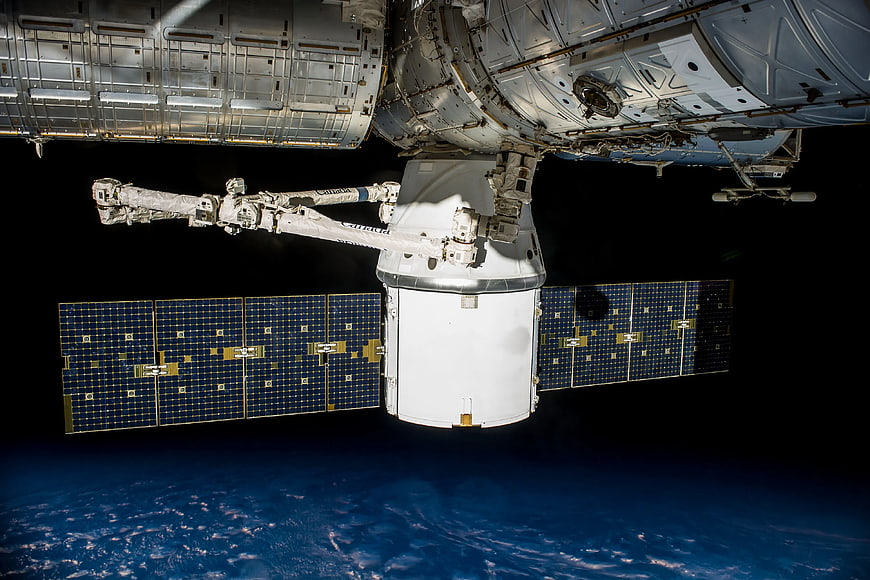 Spacecraft Docked at International Space Station Over Earth