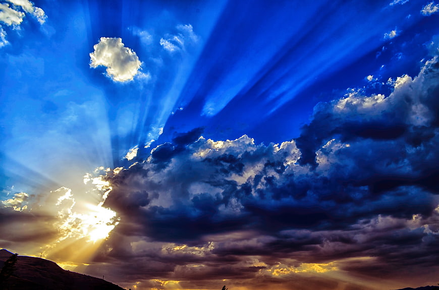 Dramatic Blue Sky with Sun Rays and Clouds