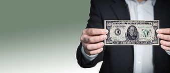Businessman in suit holding a five hundred dollar bill