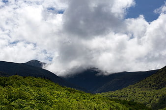 Lush Green Mountain Valley with Dramatic Clouds