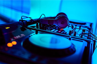 DJ Equipment with Headphones in Blue Neon Light