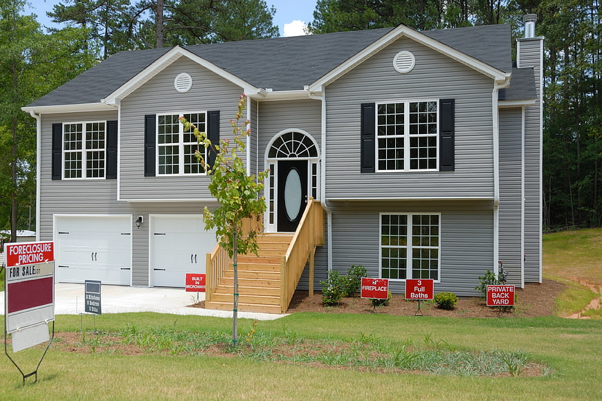 New Gray Two-Story House for Sale with Foreclosure Sign
