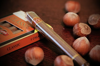 Hazelnut Cigarillo with Box and Nuts on Wood