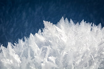 Macro Close-Up of White Frost Crystals on Blue Background