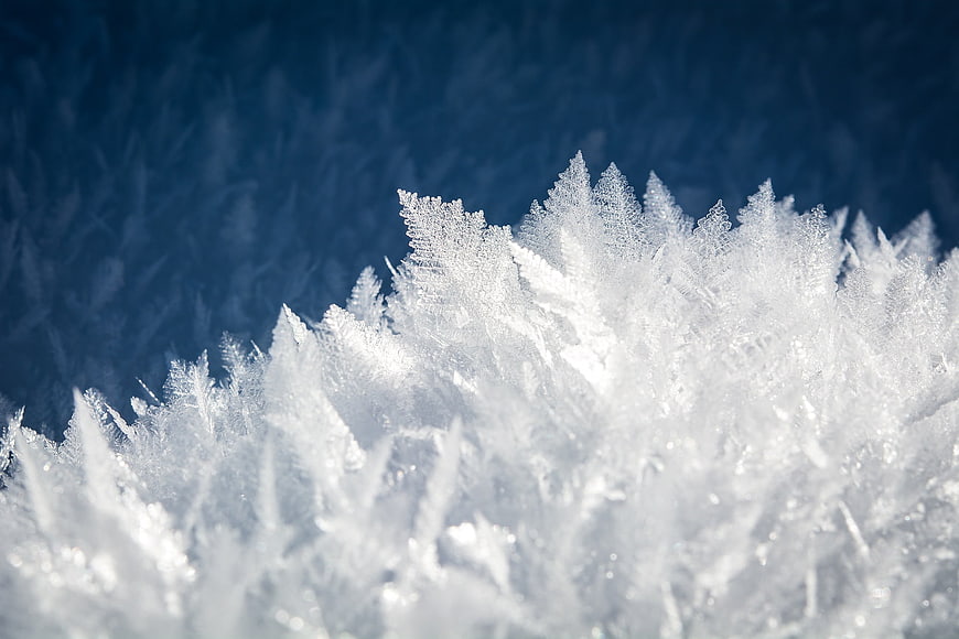 Macro Close-Up of White Frost Crystals on Blue Background