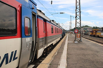 Korean passenger train at station platform with overhead wires