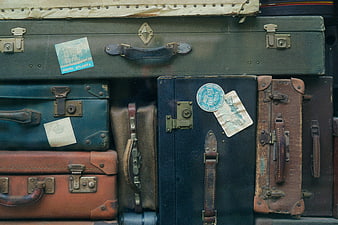 Vintage Suitcases with Travel Stickers and Luggage Tags