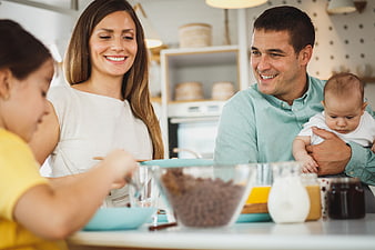 Happy family baking together in a bright modern kitchen