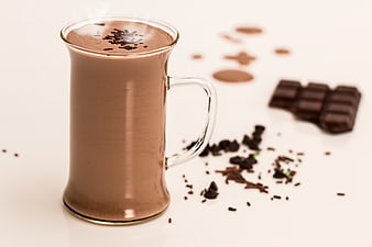 Steaming Hot Chocolate in Glass Mug with Cocoa Shavings