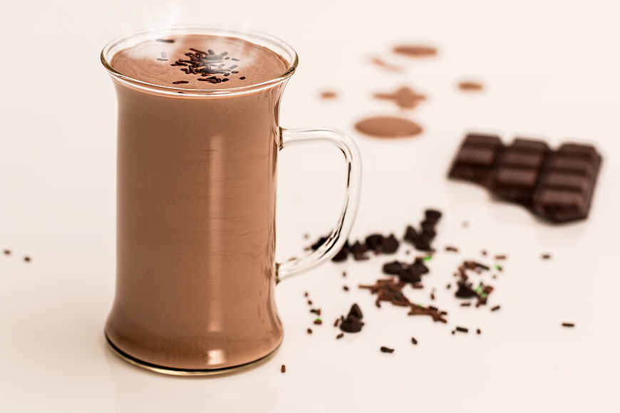 Steaming Hot Chocolate in Glass Mug with Cocoa Shavings